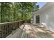 Wide angle view of back deck surrounded by mature trees and lush greenery at 3100 Templeton Ln, Loganville, GA 30052
