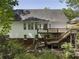 Home's backyard features a large wooden deck and lush landscaping at 3100 Templeton Ln, Loganville, GA 30052