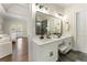 Bright bathroom features dual sink vanity, white cabinets, and shower at 3100 Templeton Ln, Loganville, GA 30052