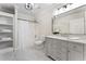 Bright bathroom featuring gray vanity, marble floor, and built-in shelving at 3100 Templeton Ln, Loganville, GA 30052