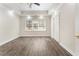 Neutral bedroom featuring wood flooring, tray ceiling, and bright trim at 3100 Templeton Ln, Loganville, GA 30052