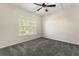 Bright bedroom with carpet, ceiling fan and a window letting in natural light at 3100 Templeton Ln, Loganville, GA 30052