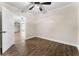 Neutral bedroom showing wood flooring, ceiling fan, and trim with open doorway at 3100 Templeton Ln, Loganville, GA 30052