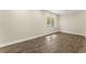 Neutral bedroom featuring wood flooring, large window, and bright trim at 3100 Templeton Ln, Loganville, GA 30052