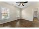 Empty bedroom with hardwood floors, ceiling fan, and natural light at 3100 Templeton Ln, Loganville, GA 30052