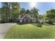 Charming brick home with a well-manicured lawn, attached garage and inviting front porch at 3100 Templeton Ln, Loganville, GA 30052