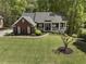 Well-maintained brick house with a large front yard and mature trees at 3100 Templeton Ln, Loganville, GA 30052
