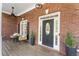 Charming front porch featuring a detailed front door and comfortable seating area at 3100 Templeton Ln, Loganville, GA 30052