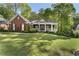 Charming single-story brick home with a welcoming front porch and manicured lawn at 3100 Templeton Ln, Loganville, GA 30052