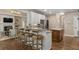 Gourmet kitchen with a breakfast bar, stainless appliances, and an open layout to the living room at 3100 Templeton Ln, Loganville, GA 30052