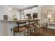 Eat-in kitchen featuring counter seating, stainless appliances, and sleek white cabinetry at 3100 Templeton Ln, Loganville, GA 30052
