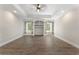 Living room featuring built-in bookshelves, recessed lighting, and stylish wood laminate floors at 3100 Templeton Ln, Loganville, GA 30052