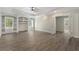 Open living room with built-in shelves, wood laminate flooring, and natural light from windows at 3100 Templeton Ln, Loganville, GA 30052
