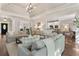 Open-concept living room with fireplace, hardwood floors, and an adjoining kitchen area for easy entertaining at 3100 Templeton Ln, Loganville, GA 30052