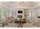 Bright living room with a brick fireplace, hardwood floors, and large windows offering ample natural light at 3100 Templeton Ln, Loganville, GA 30052