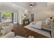 Bright bedroom with tray ceiling, hardwood floors, and access to private porch at 3100 Templeton Ln, Loganville, GA 30052