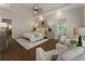 Bright bedroom with tray ceiling, hardwood floors, sitting area, and ensuite bathroom access at 3100 Templeton Ln, Loganville, GA 30052
