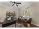 Well-lit home office featuring hardwood floors and comfortable seating at 3100 Templeton Ln, Loganville, GA 30052