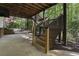 Covered patio featuring wooden stairs and lush landscaping at 3100 Templeton Ln, Loganville, GA 30052