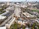 Stunning aerial view of luxury high-rise condos with city skyline, surrounding neighborhood, and tree-lined streets at 2855 Peachtree Ne Rd # 115, Atlanta, GA 30305