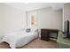 Simple bedroom featuring a bed, desk, and ample natural light, creating a perfect space for relaxation and study at 2855 Peachtree Ne Rd # 115, Atlanta, GA 30305