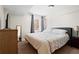 Bright bedroom featuring a bed, dresser, mirror, and a window dressed with curtains, creating a cozy atmosphere at 2855 Peachtree Ne Rd # 115, Atlanta, GA 30305