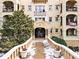 The Alhambra residential building showcases architectural details with balconies, landscaping, and a welcoming entrance at 2855 Peachtree Ne Rd # 115, Atlanta, GA 30305