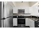 Bright kitchen showcases stainless steel appliances, white cabinets, and dark countertops at 2855 Peachtree Ne Rd # 115, Atlanta, GA 30305