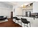 Cozy living space with hardwood floors, breakfast bar, and view of the kitchen at 2855 Peachtree Ne Rd # 115, Atlanta, GA 30305