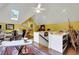Second floor art studio with yellow walls and white trim, featuring a large desk and access to the stairs at 3835 Paces Ferry Nw Rd, Atlanta, GA 30327