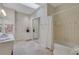 Well-lit bathroom featuring a tub/shower, tiled floors, and a sink with light countertop at 3835 Paces Ferry Nw Rd, Atlanta, GA 30327
