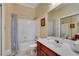 Bathroom with shower/tub combo, white tile, and a vanity with a marble countertop at 3835 Paces Ferry Nw Rd, Atlanta, GA 30327