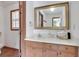 Bathroom featuring a wood vanity with a white countertop and a large framed mirror at 3835 Paces Ferry Nw Rd, Atlanta, GA 30327