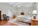 Bedroom with a four-poster bed, hardwood floors, and a ceiling fan below a skylight at 3835 Paces Ferry Nw Rd, Atlanta, GA 30327