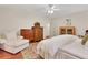 Bright bedroom featuring hardwood floors, white linens, and a seating area at 3835 Paces Ferry Nw Rd, Atlanta, GA 30327
