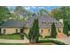 Elegant two-story home surrounded by lush landscaping and mature trees, offering privacy and curb appeal at 3835 Paces Ferry Nw Rd, Atlanta, GA 30327