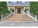 Stunning staircase leading to the front door, flanked by stone railings and mature plantings at 3835 Paces Ferry Nw Rd, Atlanta, GA 30327