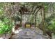 Secluded stone patio with bench and wooden pergola, creating a tranquil outdoor retreat at 3835 Paces Ferry Nw Rd, Atlanta, GA 30327