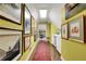 Hallway gallery space with light yellow walls, hardwood floors, and recessed lights at 3835 Paces Ferry Nw Rd, Atlanta, GA 30327