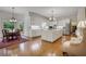 Open-concept kitchen with white cabinets, stainless steel appliances, and a large island at 3835 Paces Ferry Nw Rd, Atlanta, GA 30327