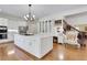 Beautiful white kitchen featuring an island, stainless steel appliances, and hardwood floors at 3835 Paces Ferry Nw Rd, Atlanta, GA 30327