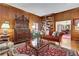Inviting living room features wood paneled walls, built-in bookshelves, and hardwood floors at 3835 Paces Ferry Nw Rd, Atlanta, GA 30327