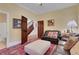 Cozy living room features a leather sofa, area rug, and stairway access at 3835 Paces Ferry Nw Rd, Atlanta, GA 30327