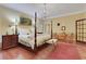 Sunny main bedroom with sitting area, four poster bed and decorative rug at 3835 Paces Ferry Nw Rd, Atlanta, GA 30327