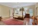 Spacious main bedroom with four-poster bed and sitting area at 3835 Paces Ferry Nw Rd, Atlanta, GA 30327