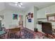 Office space with light green walls, hardwood floors, multiple art pieces, and a ceiling fan at 3835 Paces Ferry Nw Rd, Atlanta, GA 30327