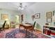 Home office with light green walls, hardwood floors, an oriental rug, and multiple desks at 3835 Paces Ferry Nw Rd, Atlanta, GA 30327