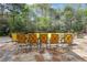 Stone patio featuring iron furniture and a seating area surrounded by mature trees at 3835 Paces Ferry Nw Rd, Atlanta, GA 30327