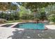 Backyard pool and spa area with a waterfall feature, mature trees and lush lawn at 3835 Paces Ferry Nw Rd, Atlanta, GA 30327