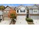 Charming townhome featuring a two-car garage, manicured landscaping, and a welcoming facade at 5016 Whiteoak Se Pointe, Smyrna, GA 30080